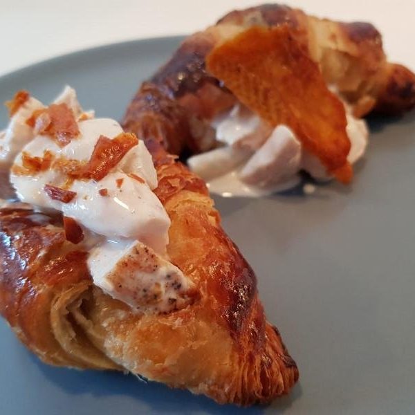 Homemade chicken salad with croissant and chicken skin