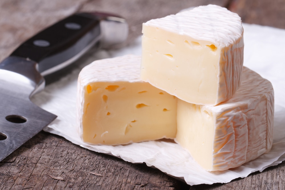 Brie,Cheese,On,Old,Wooden,Table,And,Knife,Closeup