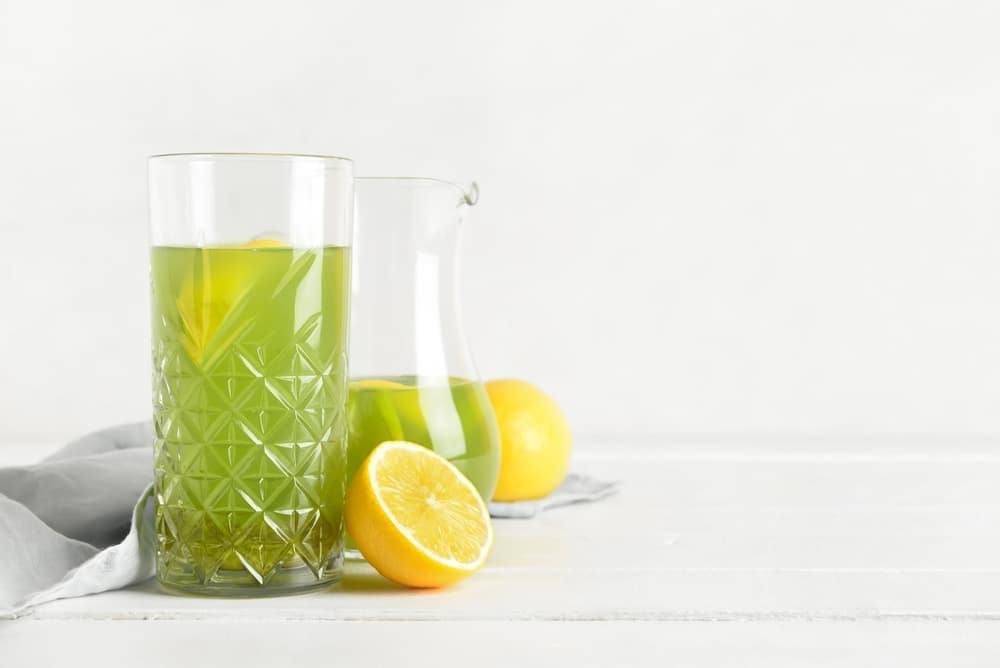 Glass,With,Tasty,Lemonade,On,Light,Wooden,Table