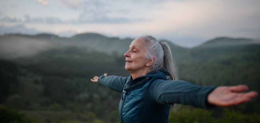 Senior,Woman,Doing,Breathing,Exercise,In,Nature,On,Early,Morning