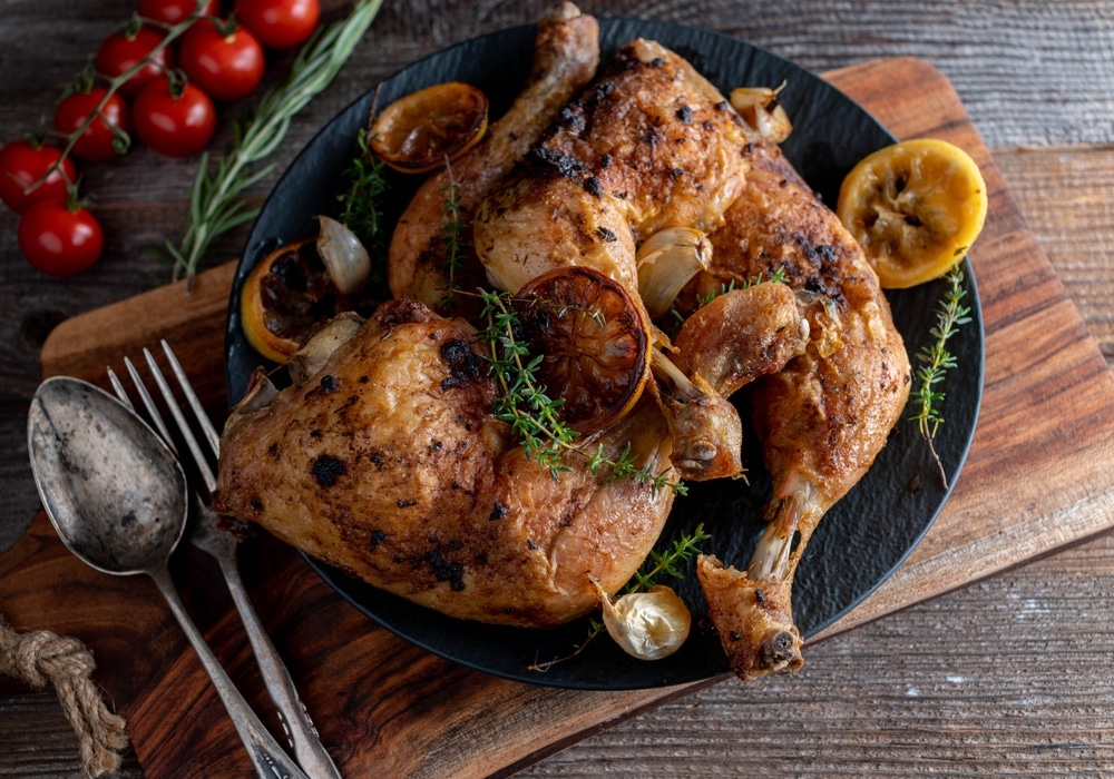 Roasted,Chicken,Legs,With,Lemon,,Thyme,And,Garlic,On,Wooden
