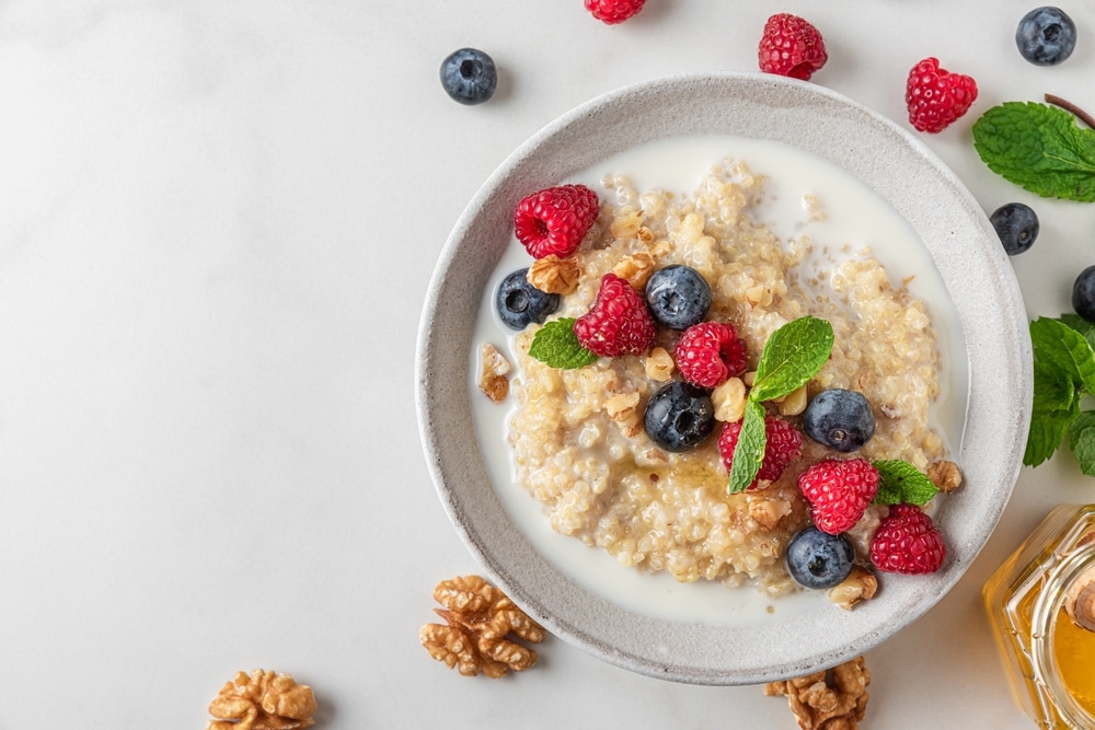 Healthy,Breakfast.,Quinoa,Porridge,With,Fresh,Berries,,Nuts,And,Mint