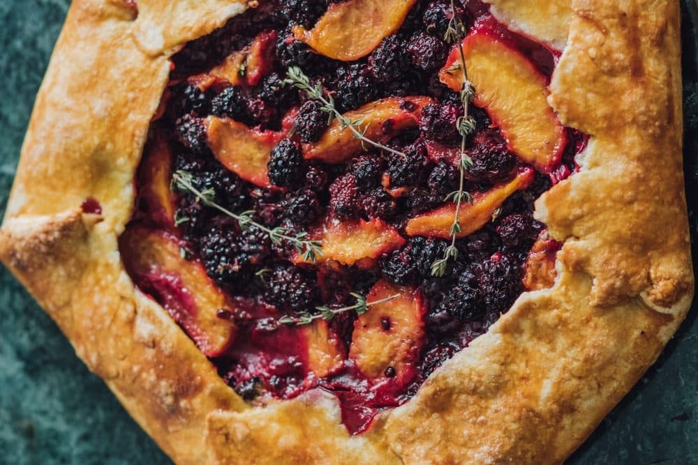 Peach,,Blackberry,,Thyme,Galette,Close,Up,On,Green,Stone,Background