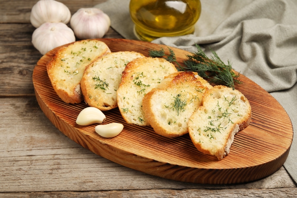 Tasty,Baguette,With,Garlic,,Dill,And,Oil,On,Wooden,Table