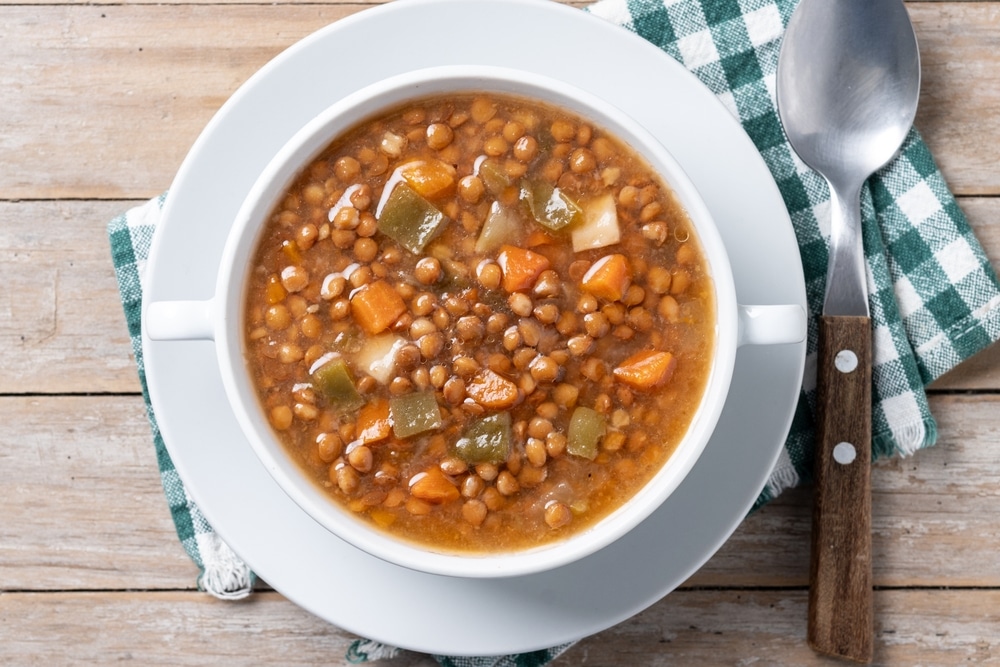 Lentil,Soup,With,Vegetables,In,Bowl,On,Wooden,Table.,Top