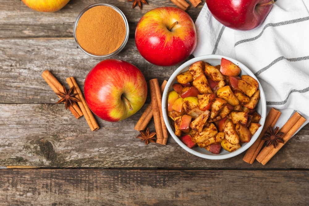 Apples,With,Cinnamon,On,A,Textured,Wooden,Background.,Fragrant,Red