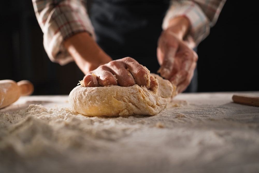 Baking,Concept.,Unrecognizable,Female,Prepares,Pastry,,Kneads,Dough,On,Wooden