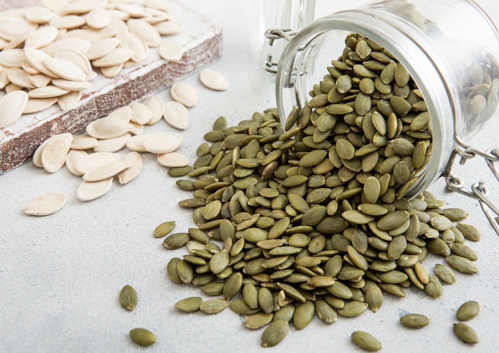 Raw,Whole,And,Peeled,Pumpkin,Seeds,In,Glass,Jar,On
