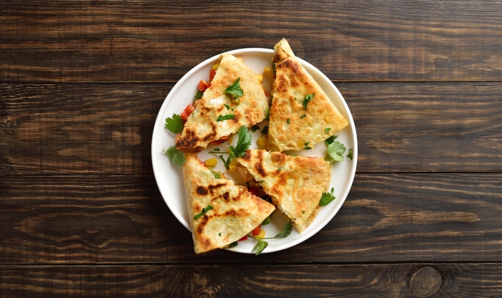 Chicken,Quesadillas,With,Fresh,Vegetables,On,White,Plate,On,Brown