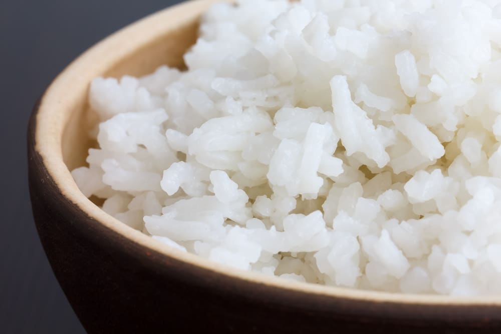 Rustic,Bowl,Of,Cooked,White,Rice,On,Dark,Surface.,Detail.