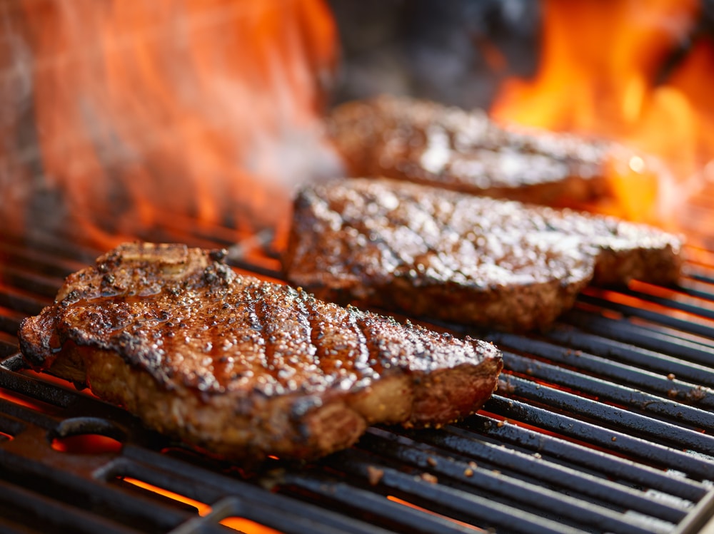 Grilling,Steaks,On,Flaming,Grill,And,Shot,With,Selective,Focus