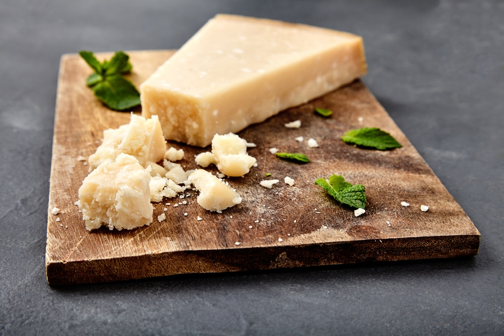 Pieces,Of,Parmigiano,Reggiano,Or,Parmesan,Cheese,On,Wood,Board