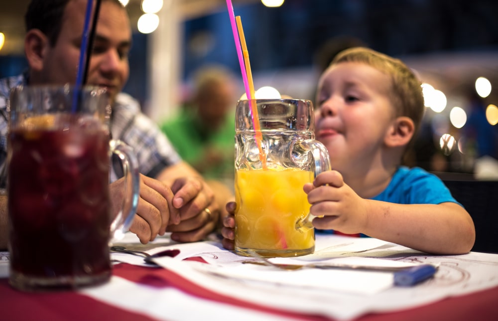 Dad,And,Son,Are,Drinking,Juices,In,Restaurant