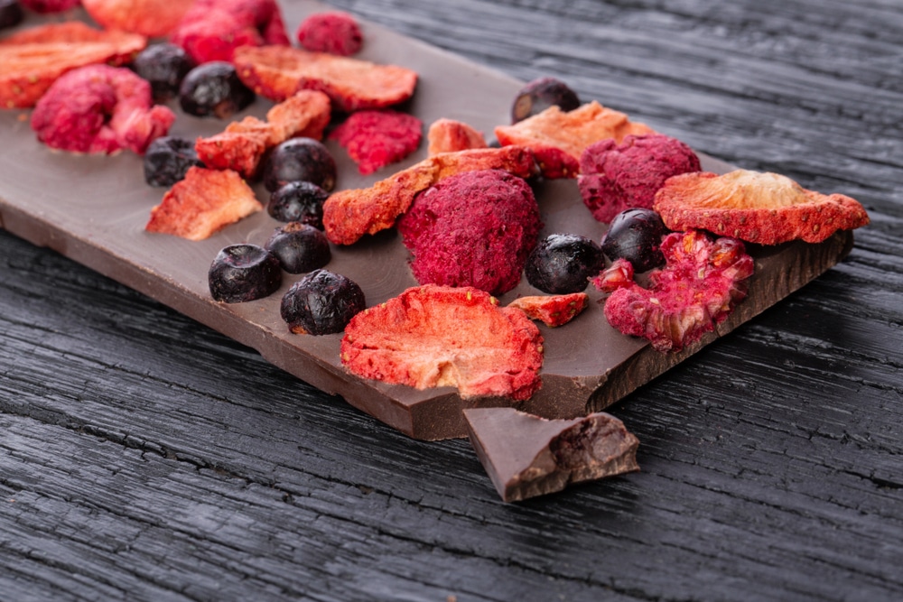 Handmade,Chocolate,Bar,With,Dried,Berries,On,A,Wooden,Black