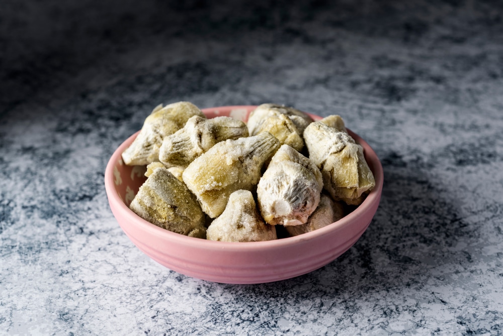 A,Pile,Of,Frozen,Artichoke,Hearts,In,A,Light,Pink