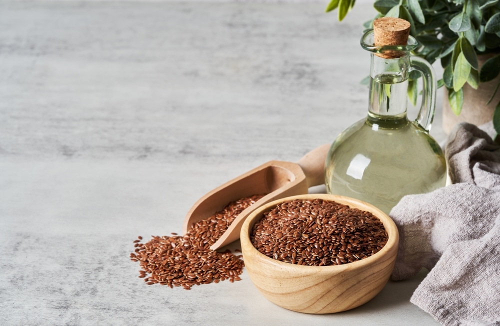 Flaxseed,Linseed,Oil,In,Wood,Bowl,On,White,Table,Background.