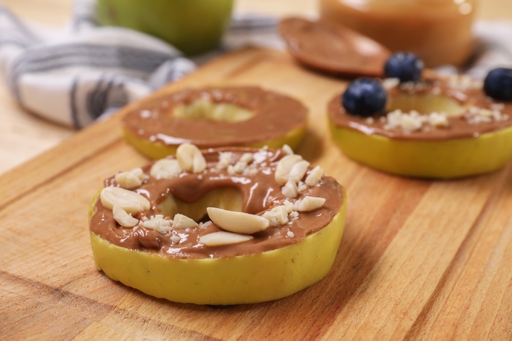 Slices,Of,Fresh,Apple,With,Nut,Butter,And,Peanuts,On
