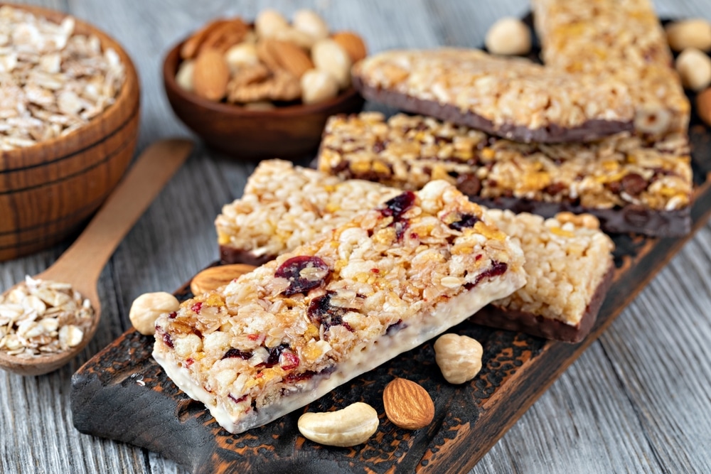 Granola,Bars,With,Nuts,And,Dried,Fruits,On,Wooden,Background