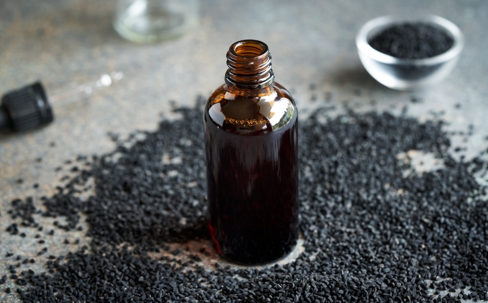 A,Bottle,Of,Black,Cumin,Or,Nigella,Seed,Oil,On