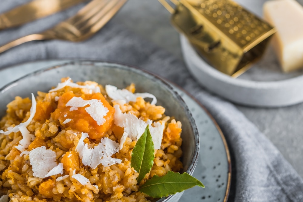 Homemade,Pumpkin,Risotto,With,Parmesan,Cheese,On,A,Gray,Concrete