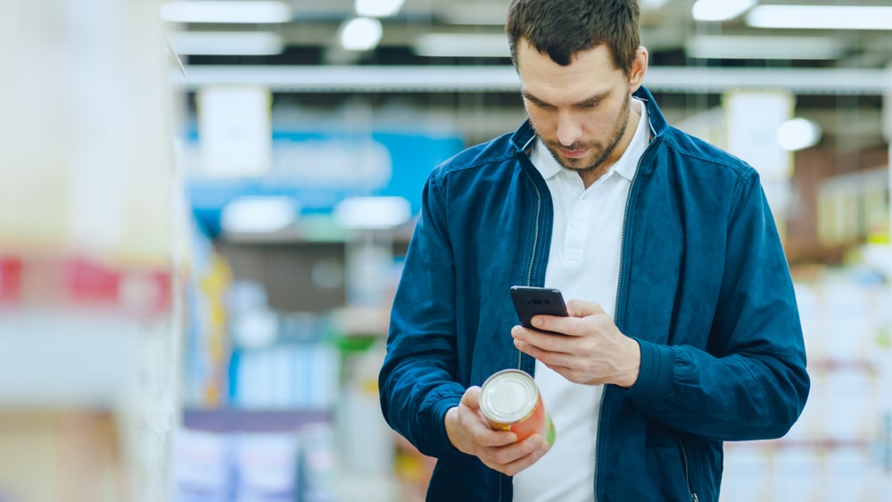 At,The,Supermarket:,Handsome,Man,Uses,Smartphone,To,Check,Nutritional