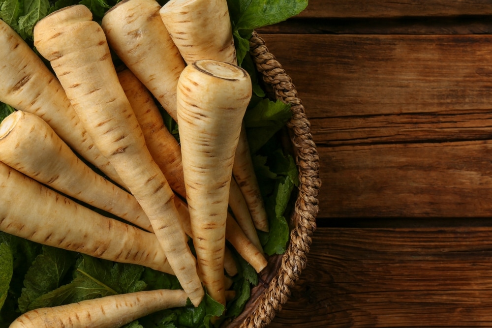 Fresh,Ripe,Parsnips,In,Wicker,Basket,On,Wooden,Table,,Top
