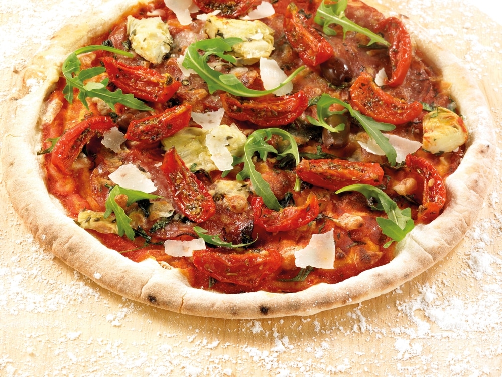 Baked,Pizza,With,Sun-dried,Tomatoes,,Arugula,Salad,,Artichoke,Hearts,,Parmesan,