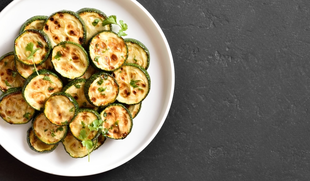 Close,Up,View,Of,Roasted,Zucchini,On,Plate,Over,Black