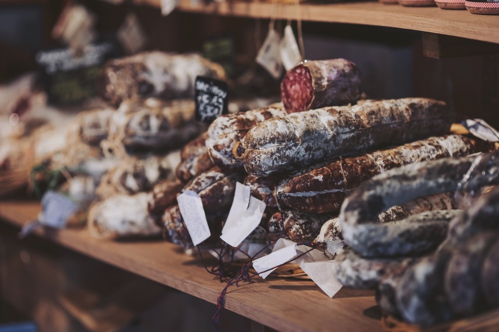 Artisan,Meats,Carefully,Arranged,On,Wooden,Shelves,In,A,Rustic