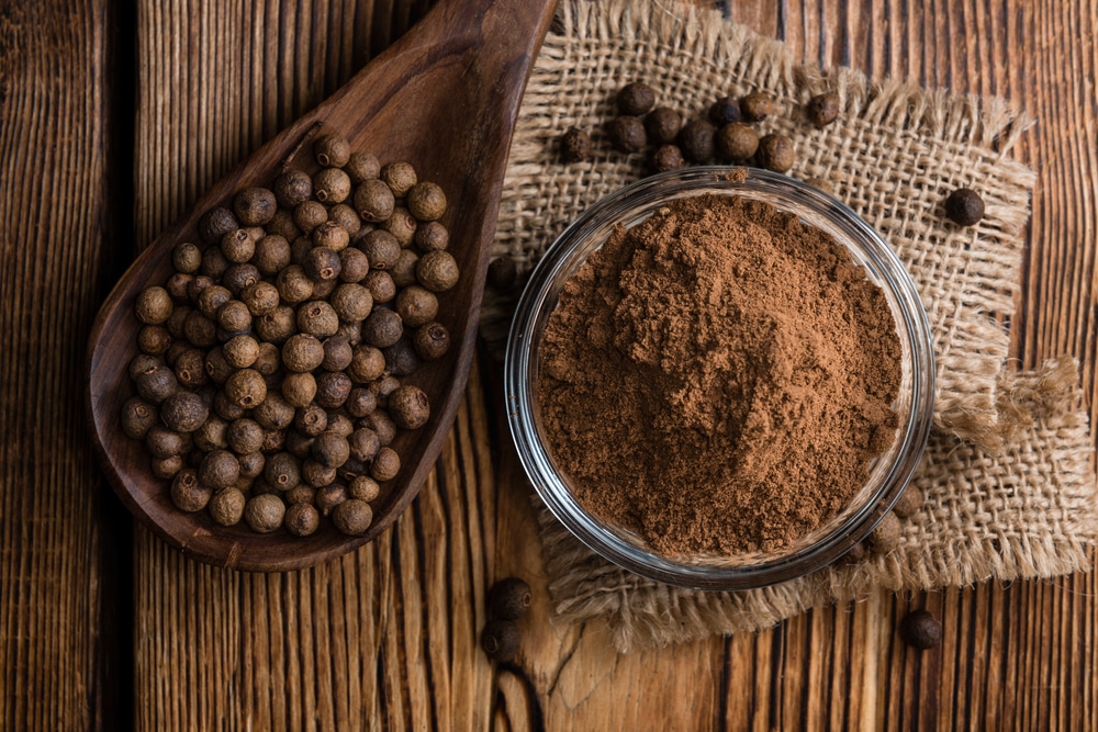 Portion,Of,Allspice,Powder,(detailed,Close-up,Shot),On,Wooden,Background